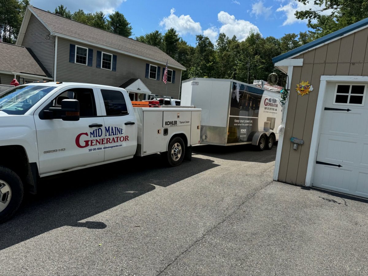 Mid Maine Generator truck and equipment trailer at a job site in Bath, Maine